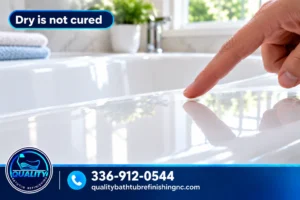Fingertip hovering above a freshly refinished bathtub surface while the coating cures